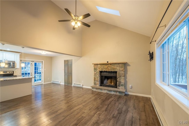 unfurnished living room with baseboard heating, ceiling fan, a fireplace, and dark hardwood / wood-style floors