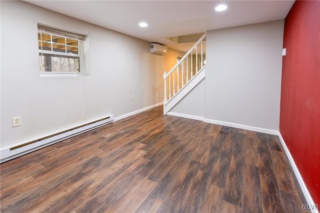 unfurnished room featuring a wall mounted AC, dark hardwood / wood-style flooring, and a baseboard heating unit