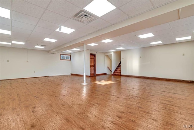 unfurnished room featuring a paneled ceiling and hardwood / wood-style floors