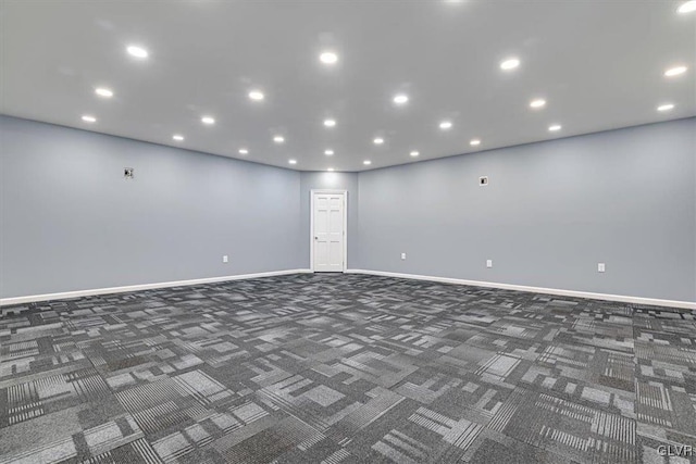 unfurnished room with dark carpet