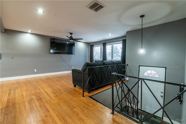 living room featuring hardwood / wood-style flooring and ceiling fan