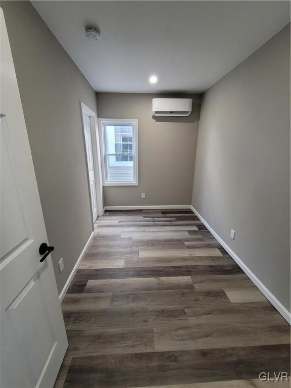 interior space featuring dark wood-type flooring and a wall mounted air conditioner