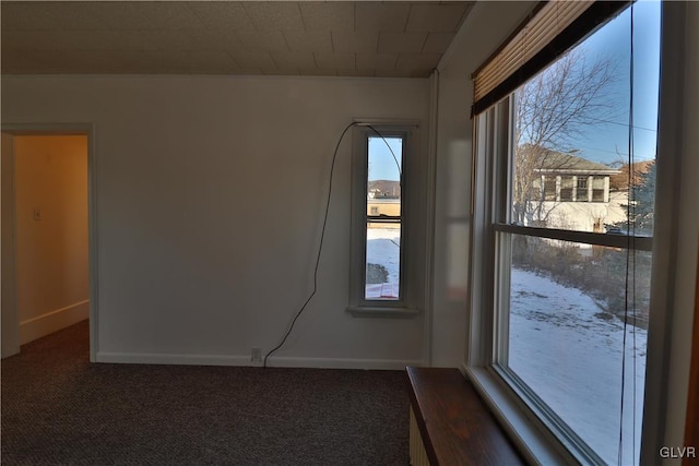 empty room featuring dark carpet