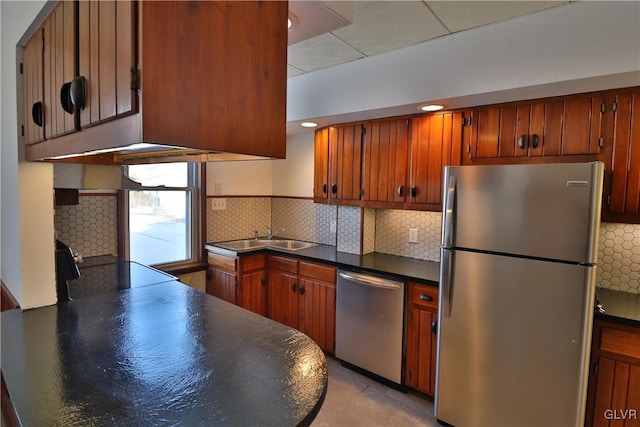 kitchen featuring stainless steel appliances, tasteful backsplash, and sink