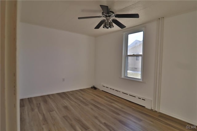 unfurnished room with hardwood / wood-style floors, a baseboard radiator, and ceiling fan