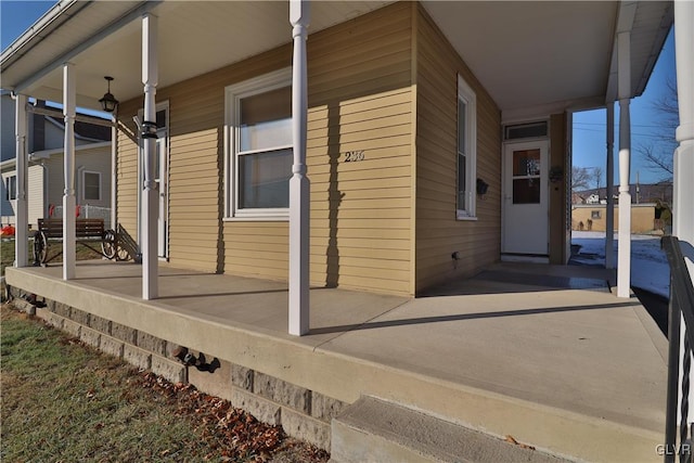 view of side of property with covered porch