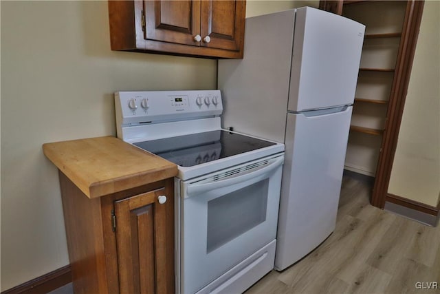 kitchen with light wood-type flooring and electric stove