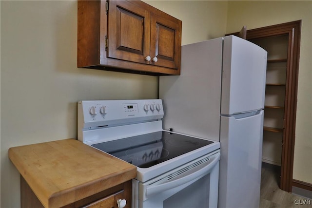 kitchen featuring white range with electric stovetop and light wood-type flooring