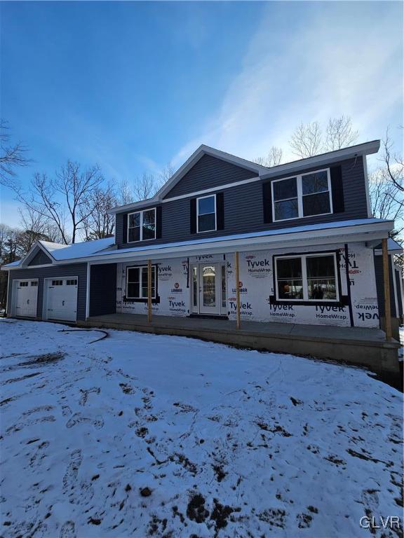 view of front property with a porch and a garage