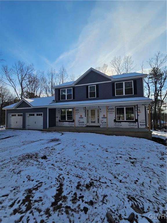 view of front property featuring a porch and a garage