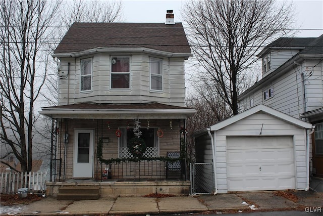 view of front facade featuring an outbuilding, a garage, and covered porch