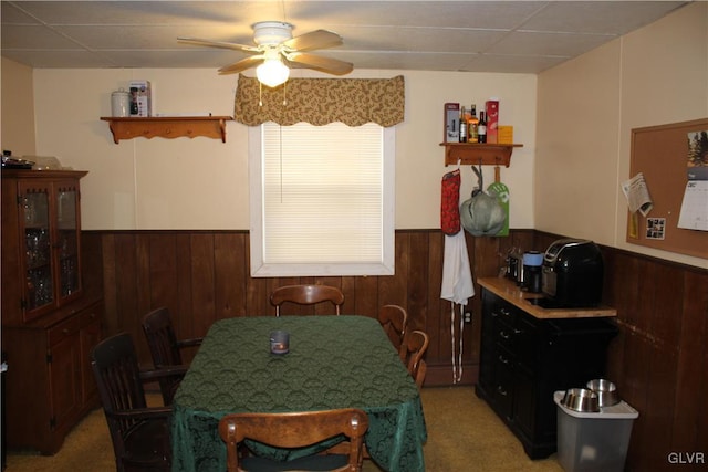 carpeted dining space featuring ceiling fan