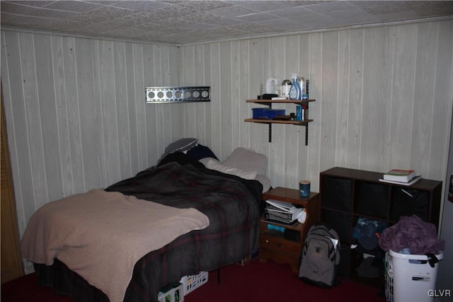 bedroom featuring wooden walls