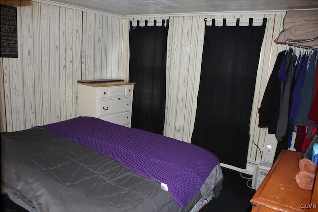 bedroom with wood walls