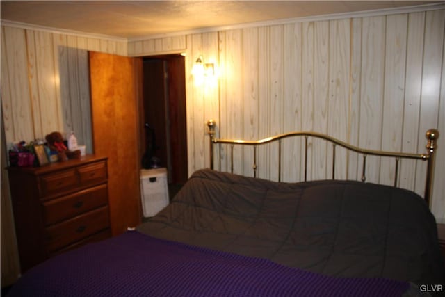 bedroom with wood walls