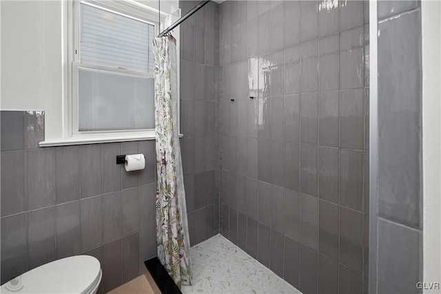 bathroom featuring toilet and walk in shower