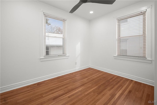 empty room featuring hardwood / wood-style flooring, ceiling fan, and crown molding