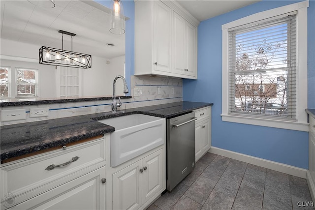 kitchen featuring stainless steel dishwasher, decorative backsplash, white cabinets, and sink