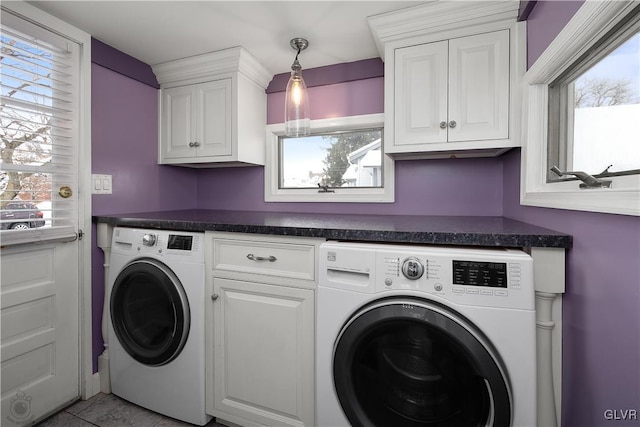 laundry room featuring cabinets, separate washer and dryer, and light tile patterned floors