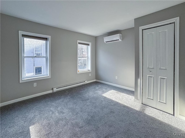 unfurnished bedroom with carpet, a closet, an AC wall unit, and baseboard heating