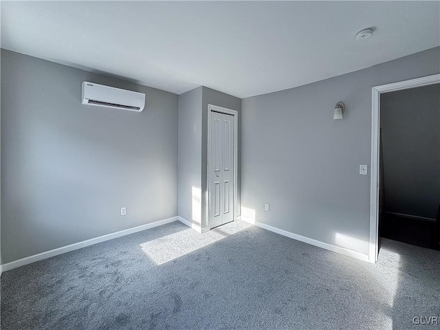 carpeted spare room featuring an AC wall unit