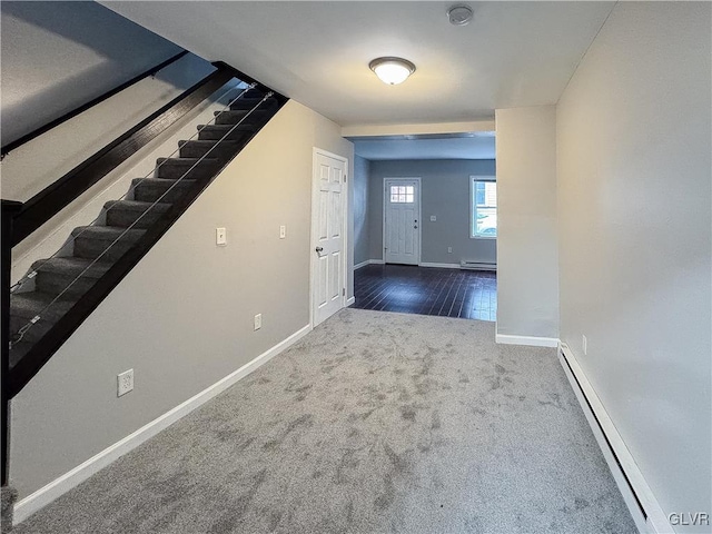 carpeted foyer entrance featuring a baseboard radiator