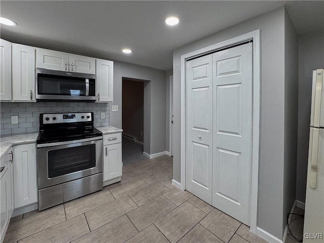 kitchen with white cabinetry, backsplash, and appliances with stainless steel finishes