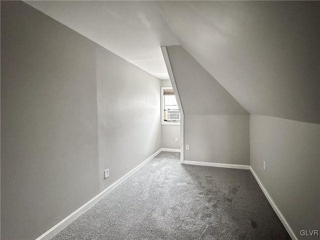 additional living space featuring carpet floors and lofted ceiling