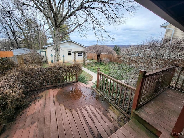 wooden terrace featuring an outbuilding