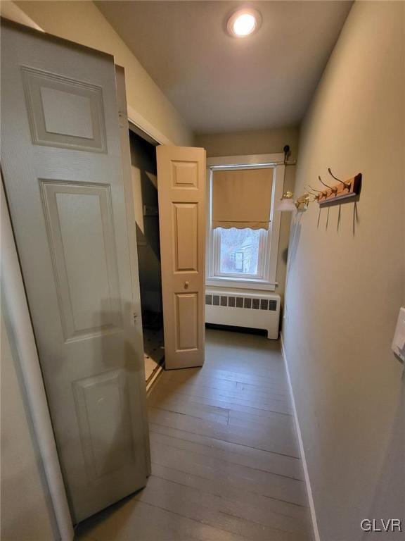 hallway with radiator and light hardwood / wood-style floors