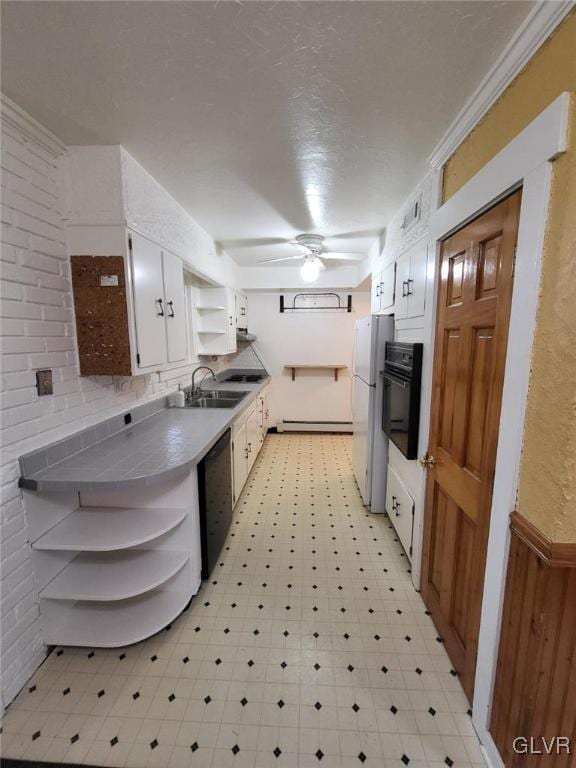 kitchen featuring white cabinetry, sink, ceiling fan, crown molding, and black appliances