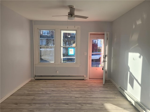 entryway with ceiling fan, light hardwood / wood-style floors, and a baseboard heating unit