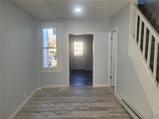 interior space featuring hardwood / wood-style floors and a baseboard heating unit