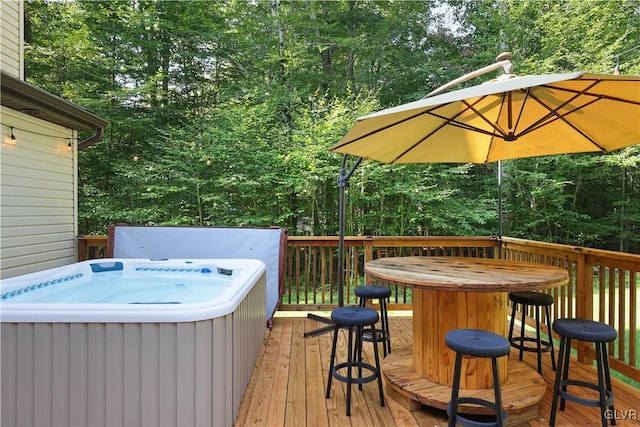 wooden deck featuring a hot tub