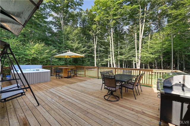 deck with a hot tub and grilling area