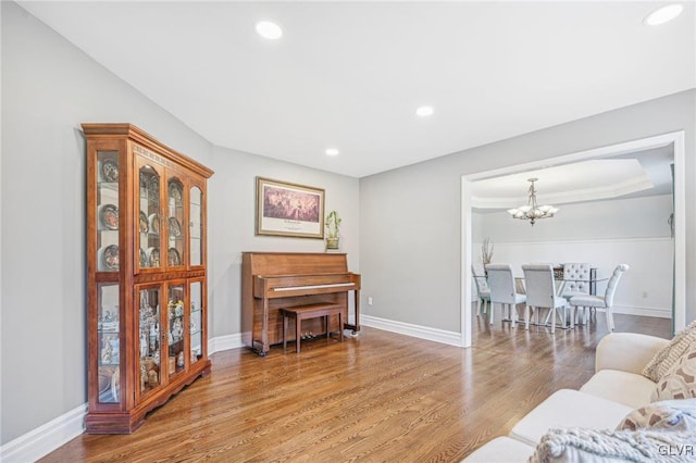 living room featuring wood-type flooring and a chandelier