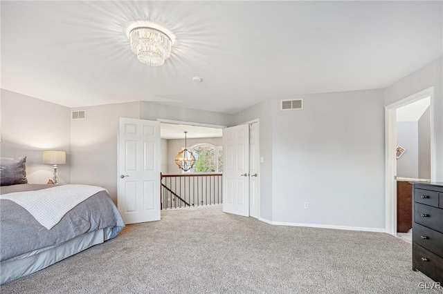 bedroom featuring carpet and a chandelier