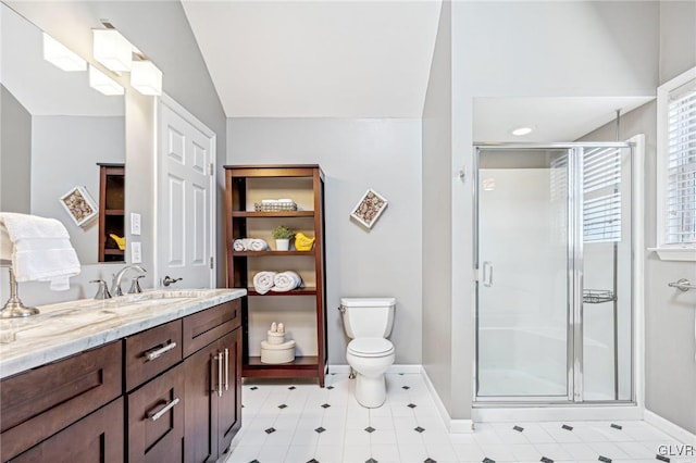 bathroom featuring vanity, toilet, a shower with door, and vaulted ceiling