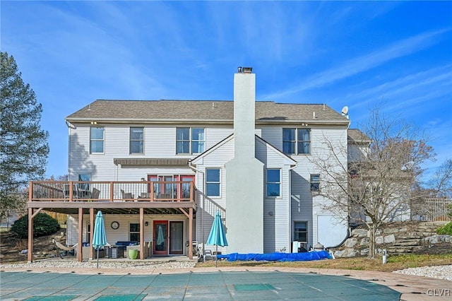 rear view of house with a patio area and a pool side deck