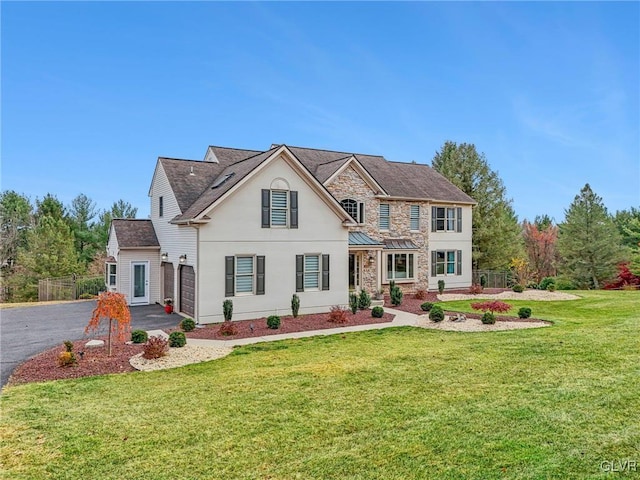 view of front of house with a front yard and a garage