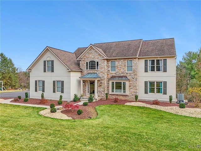 view of front of house featuring a front yard and central AC