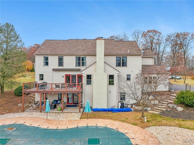 rear view of house featuring a swimming pool side deck and a patio area