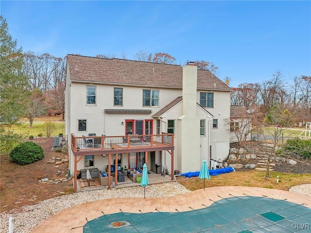 rear view of property with a pool side deck and a patio area