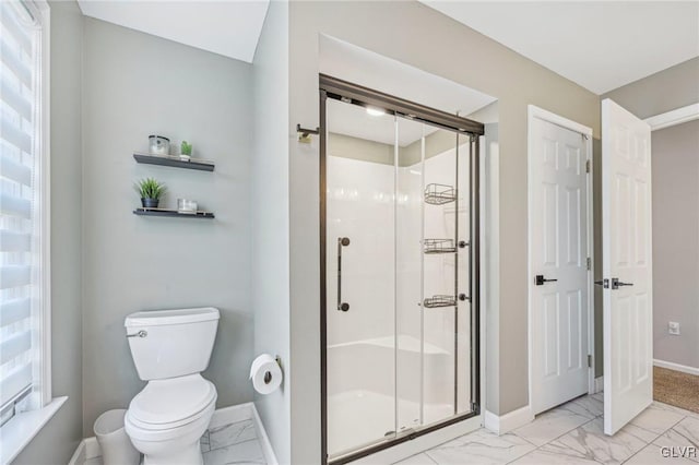 bathroom with a wealth of natural light, toilet, and walk in shower