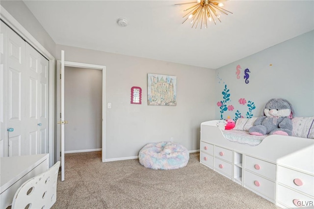 bedroom with light carpet, a closet, and a notable chandelier