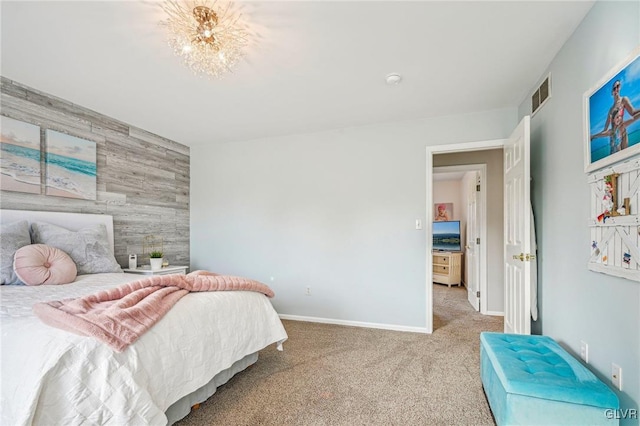 bedroom with light carpet and wood walls