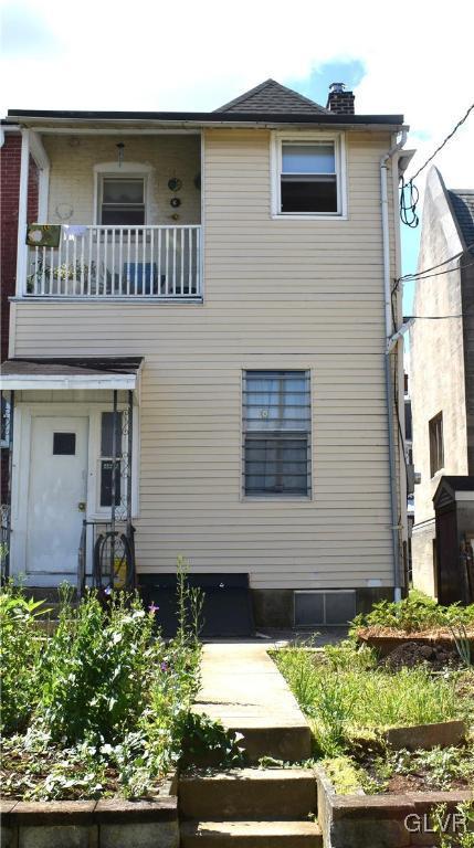 back of house with a balcony