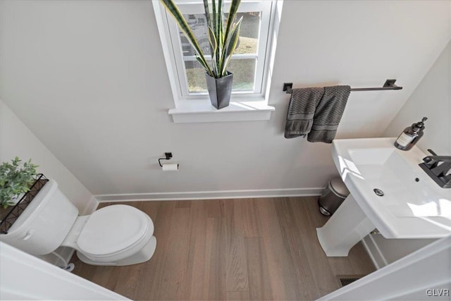 bathroom featuring hardwood / wood-style floors and toilet