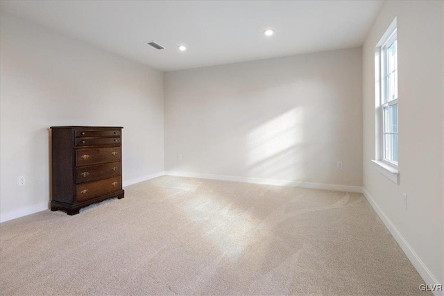 carpeted empty room with a healthy amount of sunlight