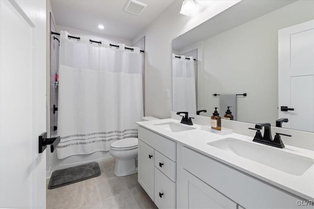 full bathroom with vanity, shower / bath combo, and toilet